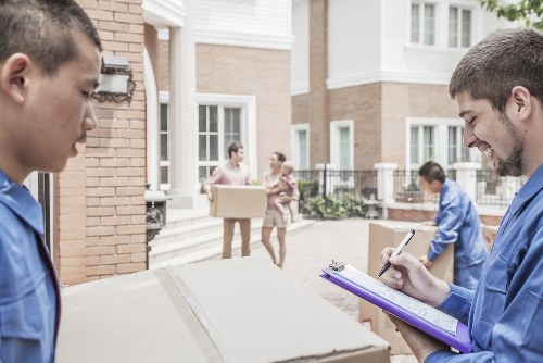 Professional packers preparing household boxes in West Kensington