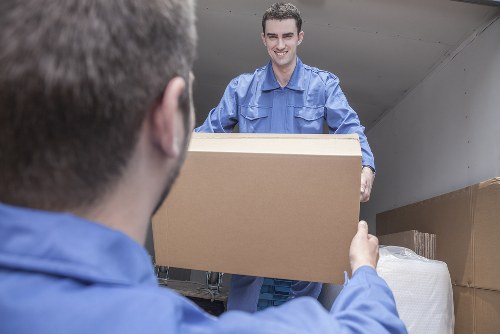 Removal team loading household furniture into a van