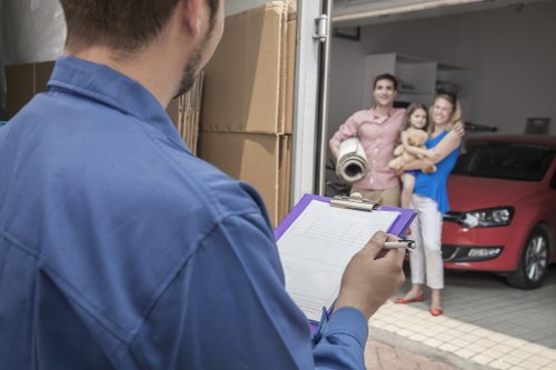 Furniture being carried through a West Kensington flat entrance