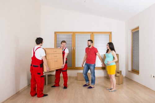 Local office relocation crew moving desks and equipment through a West Kensington building