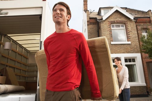 Packed moving boxes and furniture in a West Kensington flat