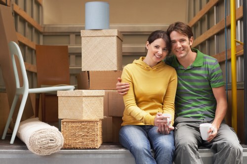 Local movers carrying household items through a West Kensington property