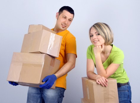 Movers using PPE and careful lifting techniques during relocation