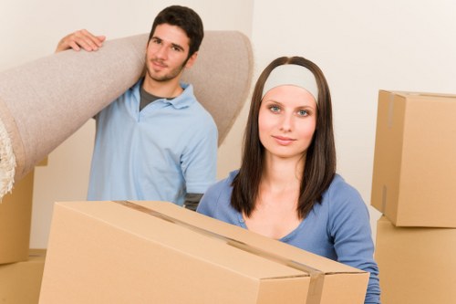 Removal team handling furniture and boxes for a West Kensington home move