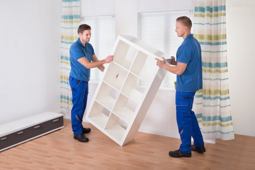Team positioning office furniture in a new commercial premises
